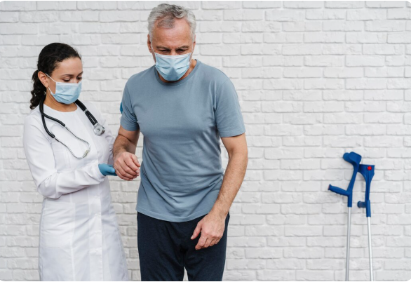 Healthcare professional assisting an older patient with walking rehabilitation during recovery.