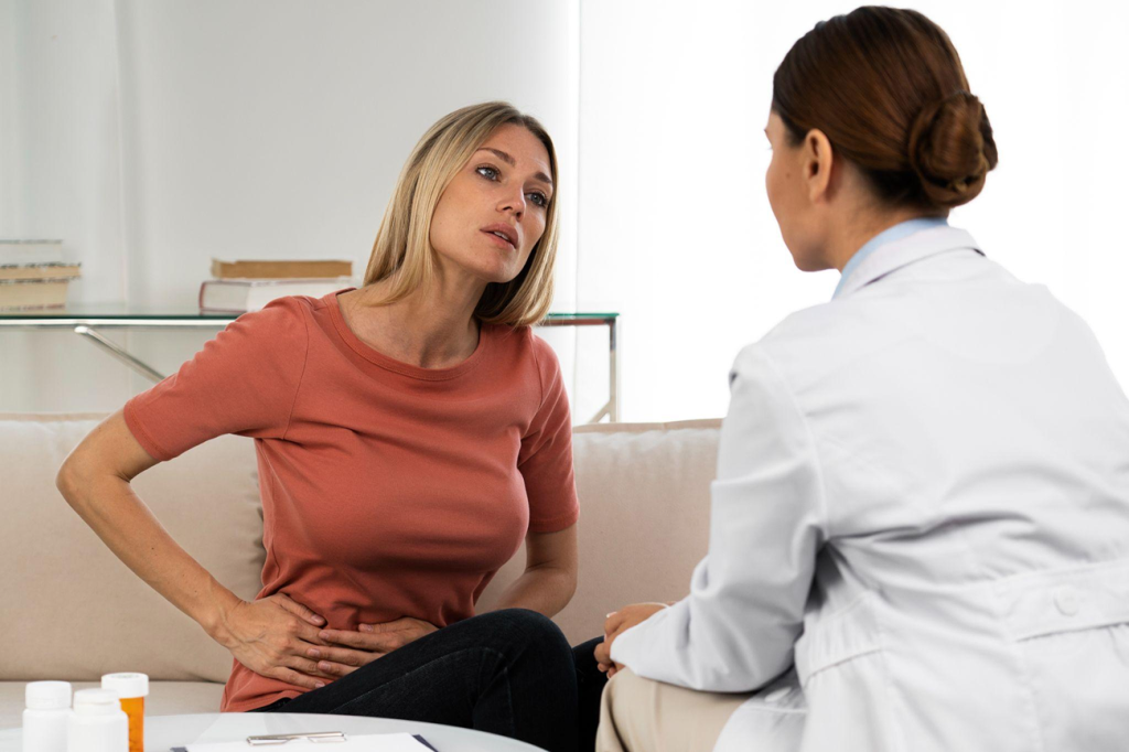 Patient discussing abdominal pain symptoms with a specialist surgeon during a consultation.