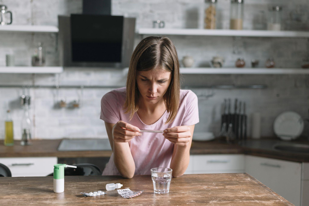 Woman reviewing medication as part of treatment for reflux, heartburn or digestive symptoms